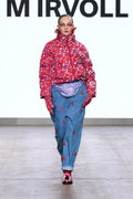 Model wearing the Pink Blossom printed quilted jacket on the catwalk.