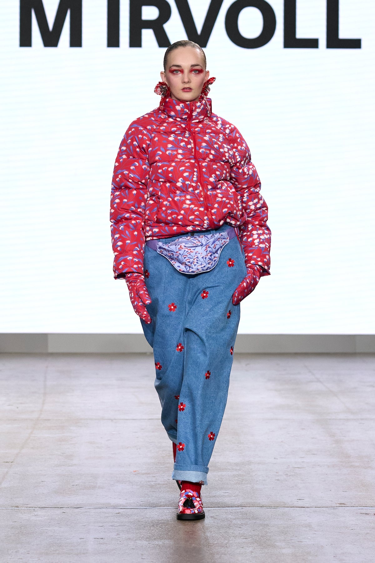 Model wearing the Pink Blossom printed quilted jacket on the catwalk.